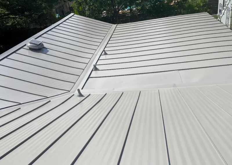 Solar attic fan installed on a metal roof for Roof Ventilation in Minneapolis